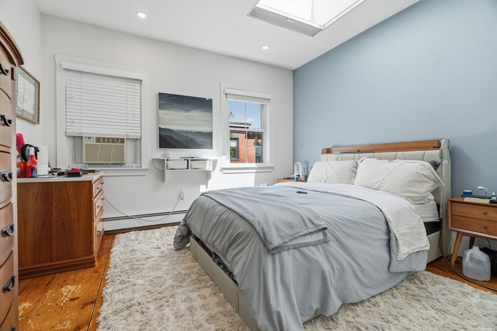 33 Mystic Street, Unit 3 Boston, MA 02129 - Photo 12 of 21 a bedroom with a bed and flat screen tv