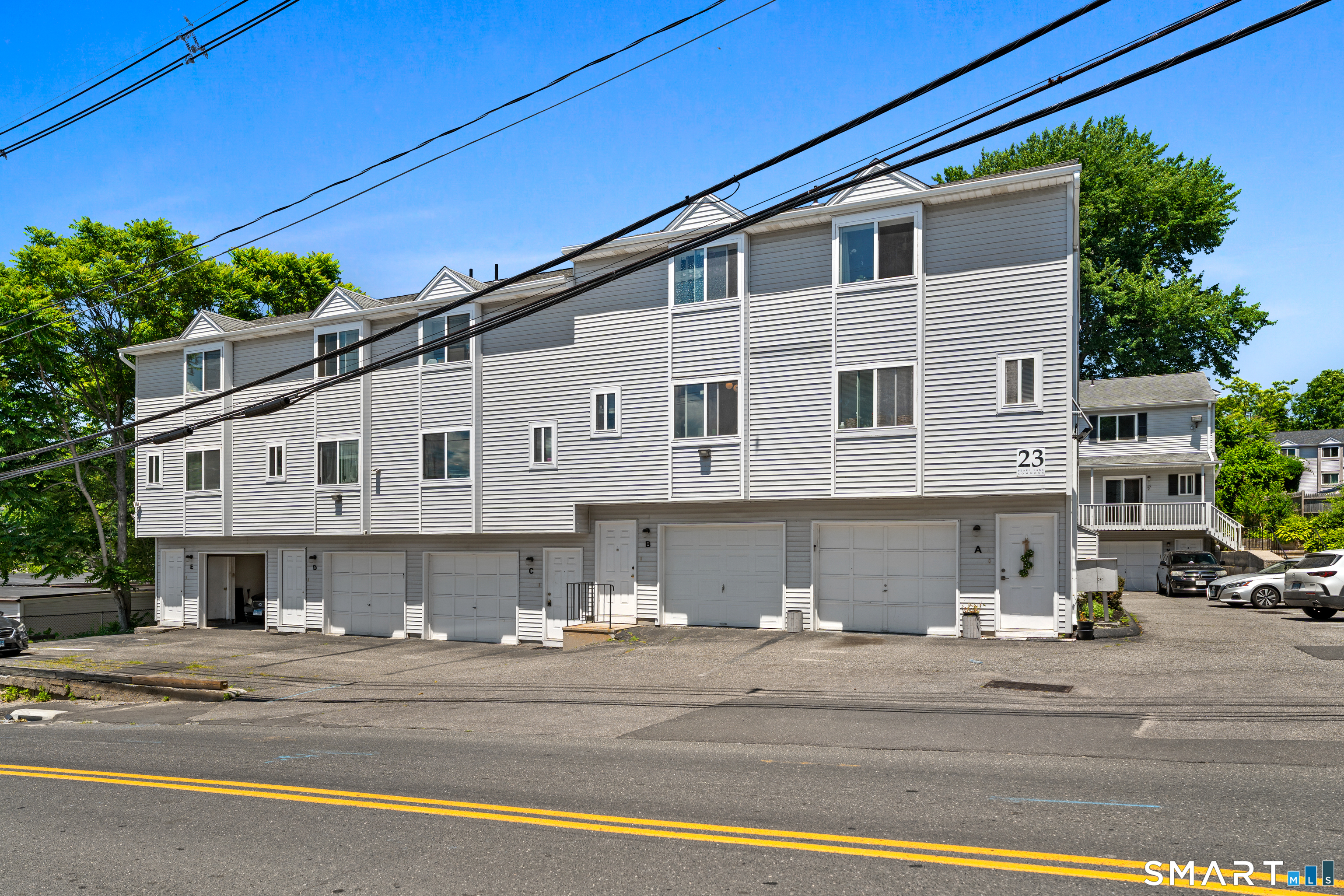 23 Pearl Lake Road, Unit B Waterbury, CT 06706 - Photo 2 of 14 a front view of a house with a road