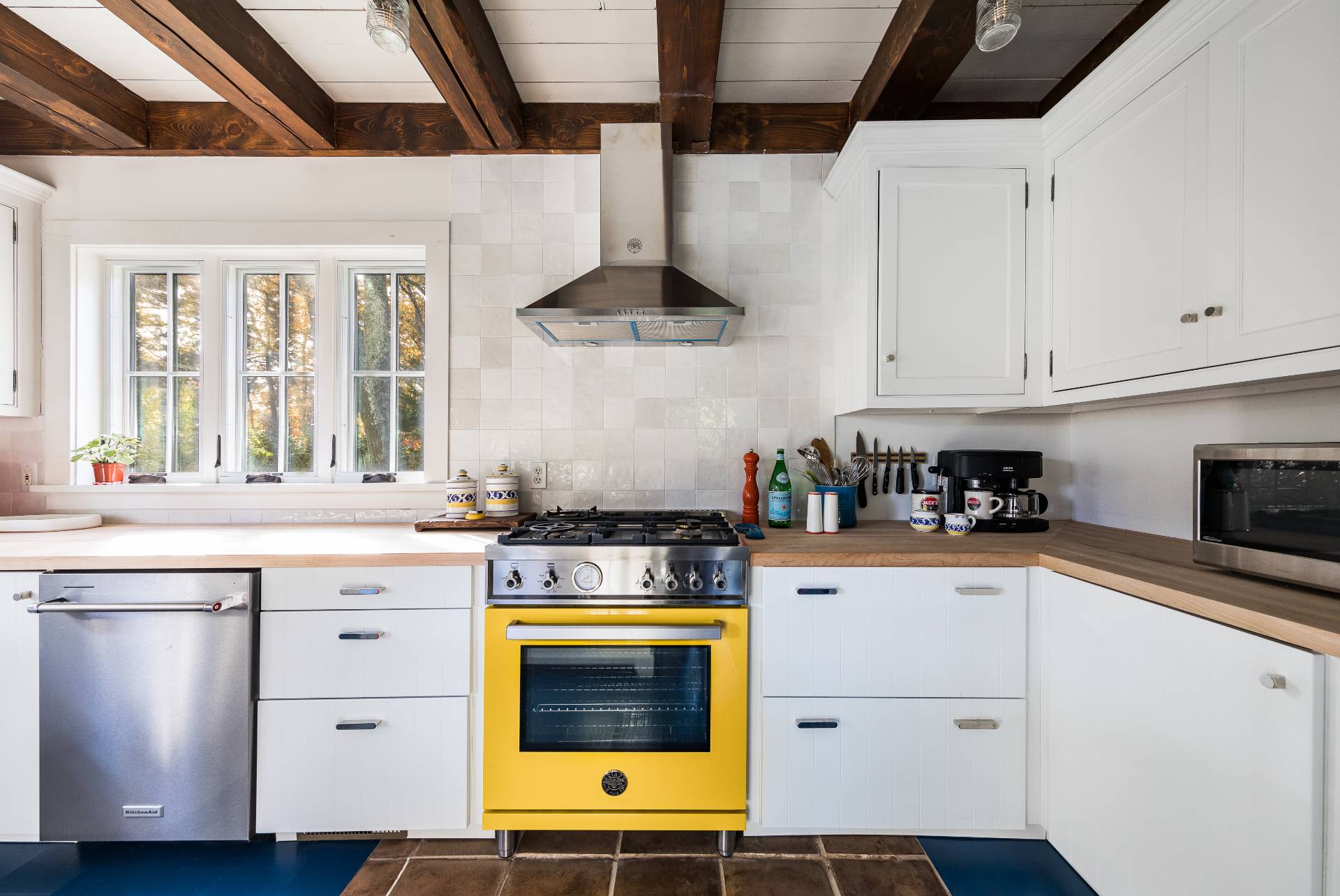 93 Wainscott NW Road Wainscott, NY 11975 - Photo 13 of 24 a kitchen with stainless steel appliances granite countertop a stove and white cabinets