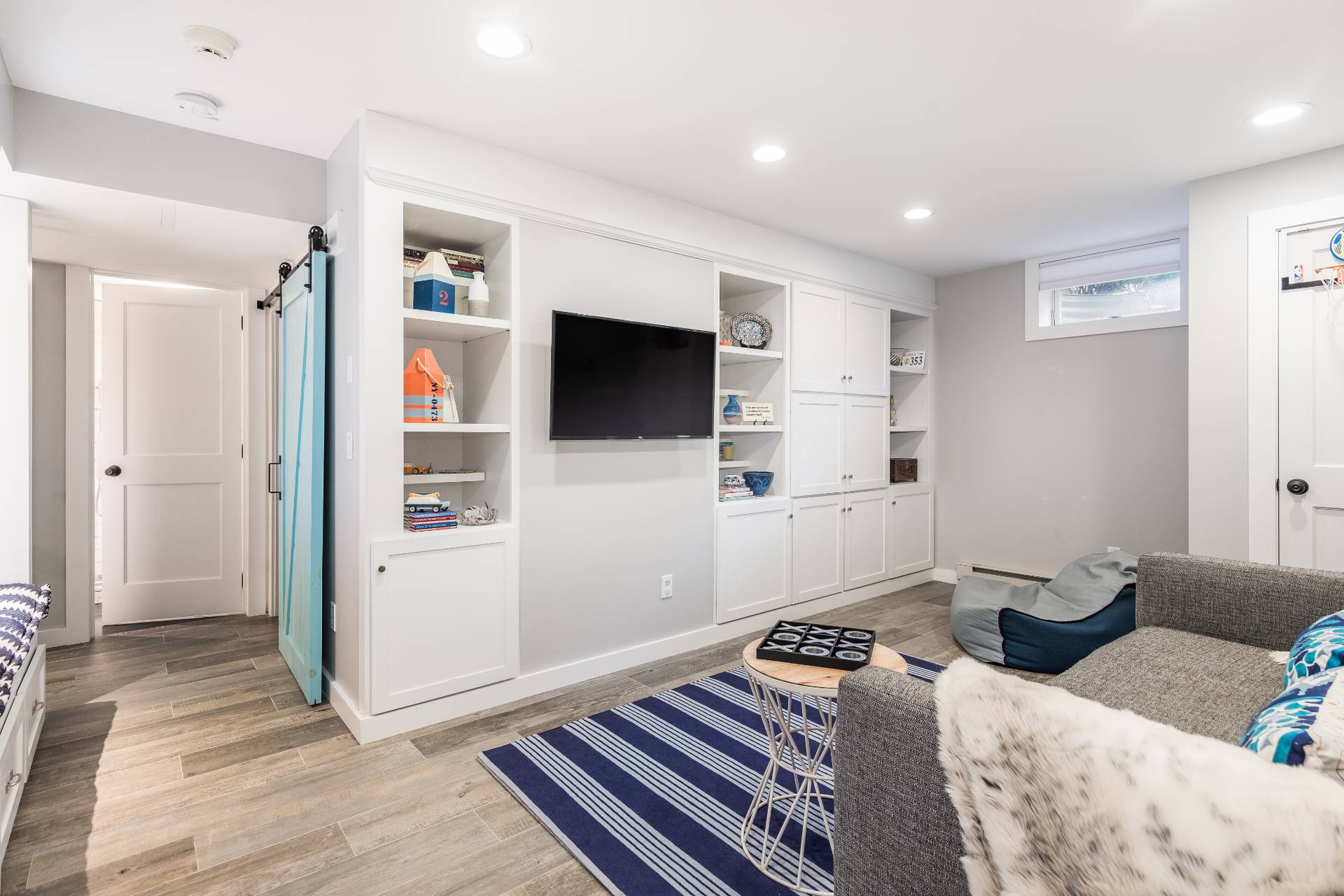 93 Wainscott NW Road Wainscott, NY 11975 - Photo 15 of 24 a bedroom with furniture and a flat screen tv