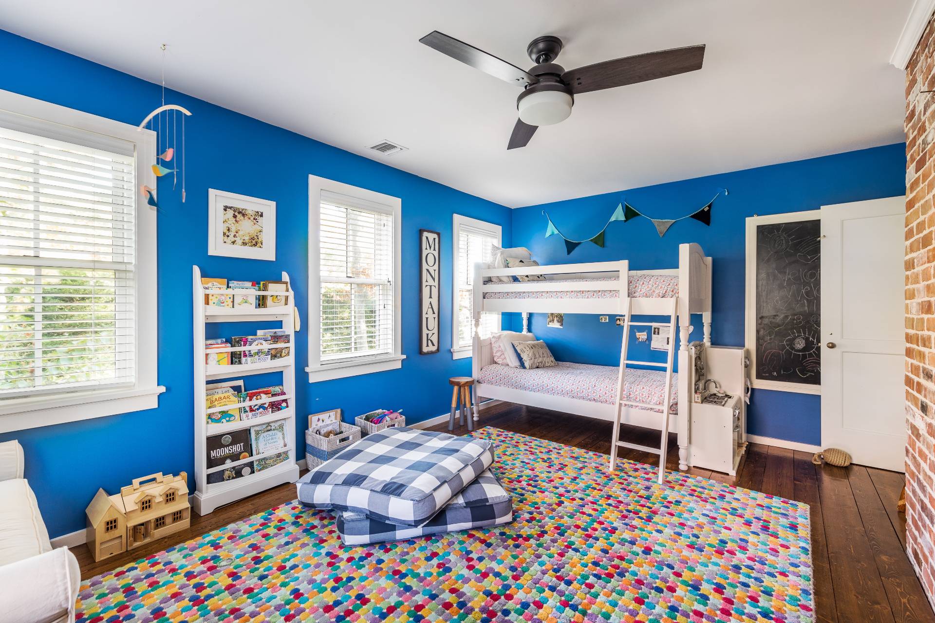 93 Wainscott NW Road Wainscott, NY 11975 - Photo 18 of 24 a bedroom with a bed and a chandelier