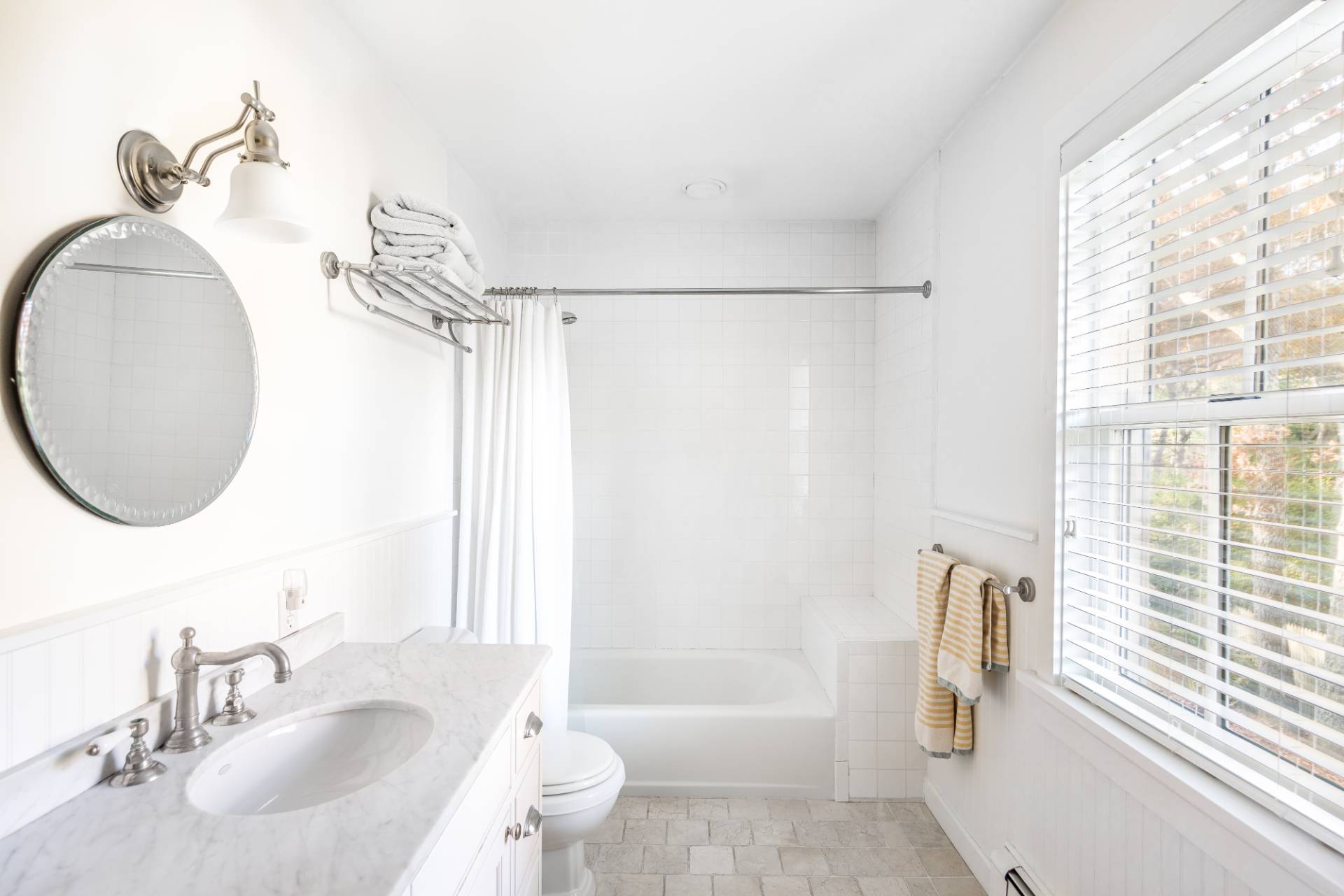 93 Wainscott NW Road Wainscott, NY 11975 - Photo 19 of 24 a bathroom with a sink a toilet and a mirror