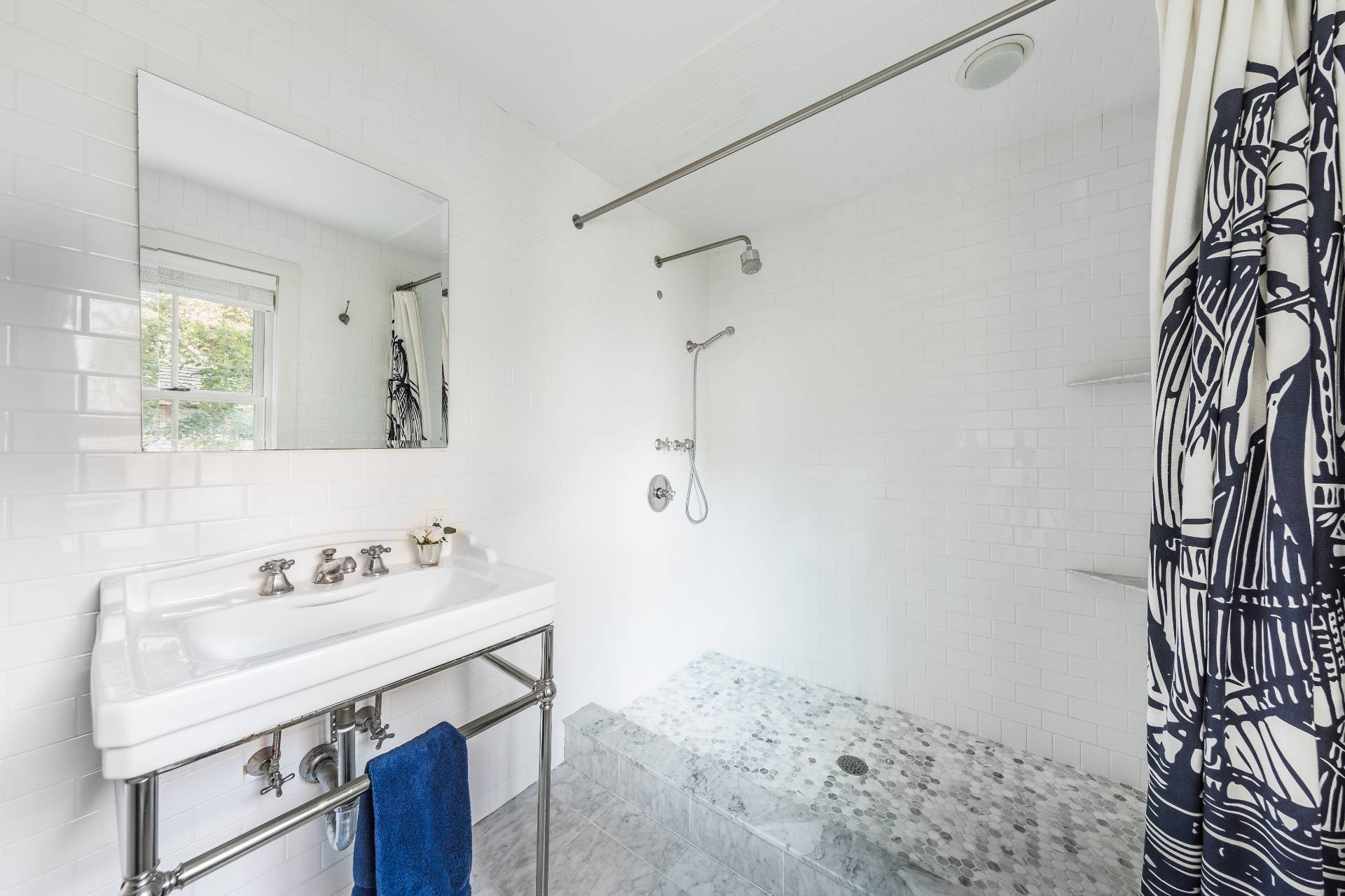 93 Wainscott NW Road Wainscott, NY 11975 - Photo 22 of 24 a bathroom with a sink and a mirror