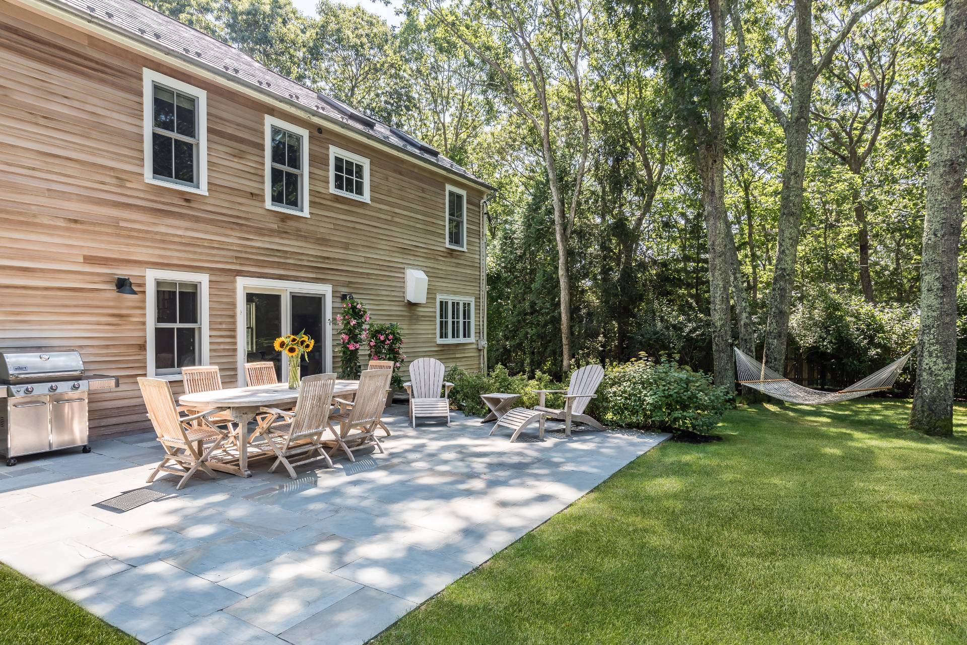 93 Wainscott NW Road Wainscott, NY 11975 - Photo 3 of 24 a view of a house with backyard sitting area and garden