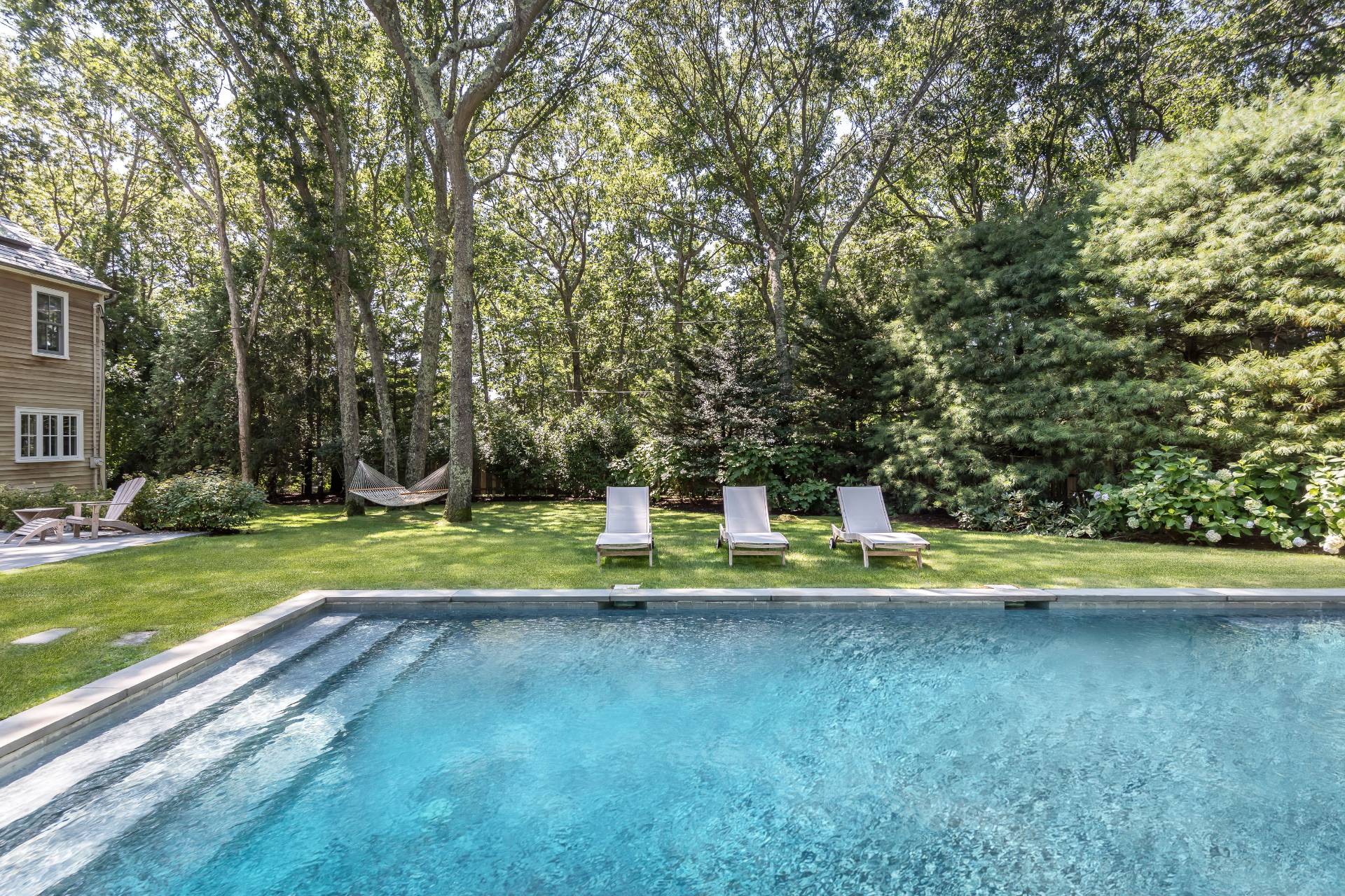 93 Wainscott NW Road Wainscott, NY 11975 - Photo 5 of 24 a view of a swimming pool with a yard