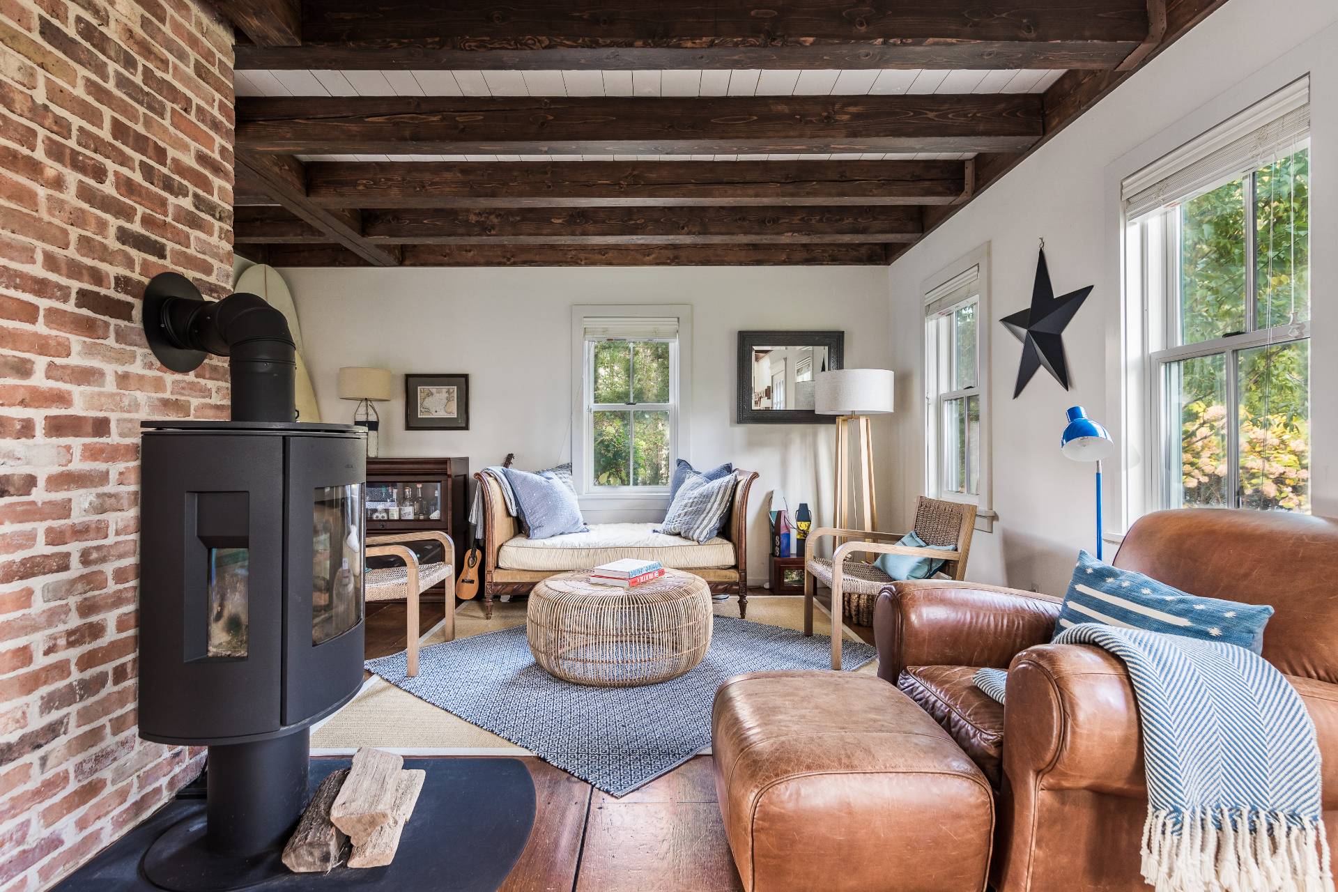 93 Wainscott NW Road Wainscott, NY 11975 - Photo 7 of 24 a living room with furniture a fireplace and a floor to ceiling window