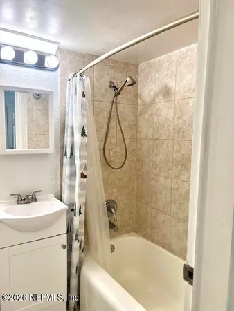 a bathroom with a bath tub a sink and a shower