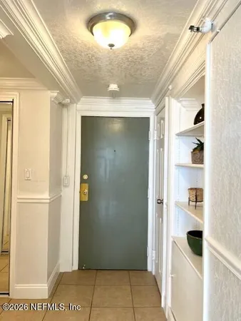 a view of a dining room with furniture and a window