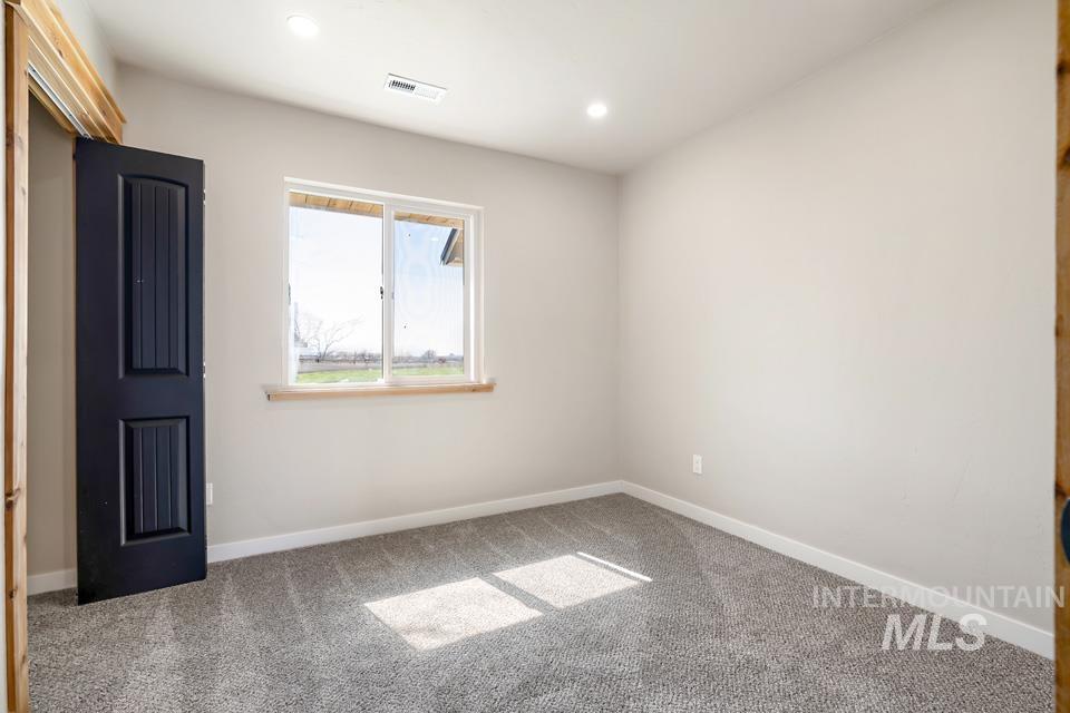 535 Day Road Weiser, ID 83672 - Photo 8 of 44 Unfurnished room with light colored carpet and recessed lighting