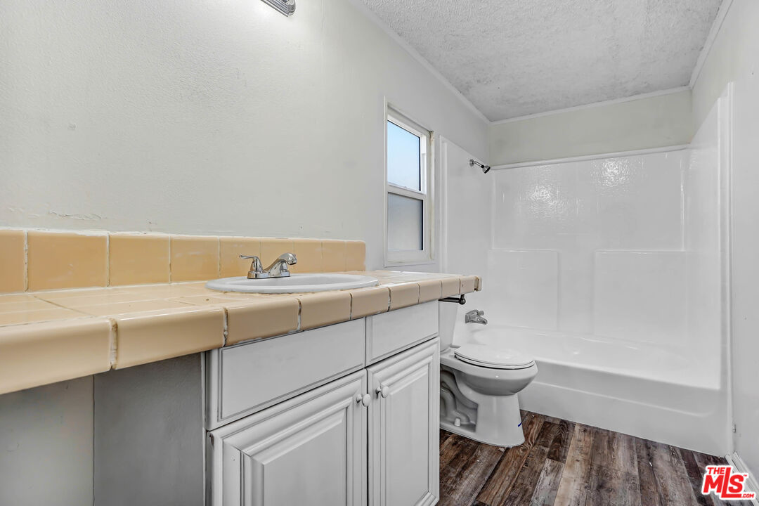 11351 Eaby Road Phelan, CA 92371 - Photo 11 of 23 a bathroom with a sink a toilet and a bathtub
