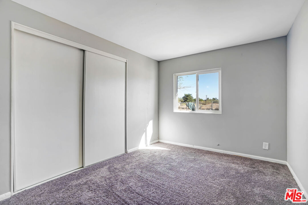 11351 Eaby Road Phelan, CA 92371 - Photo 13 of 23 a view of an empty room with a window