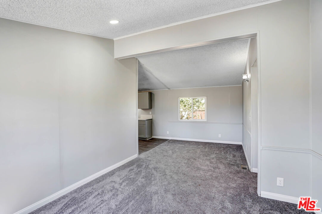 11351 Eaby Road Phelan, CA 92371 - Photo 3 of 23 an empty room with windows and entrance