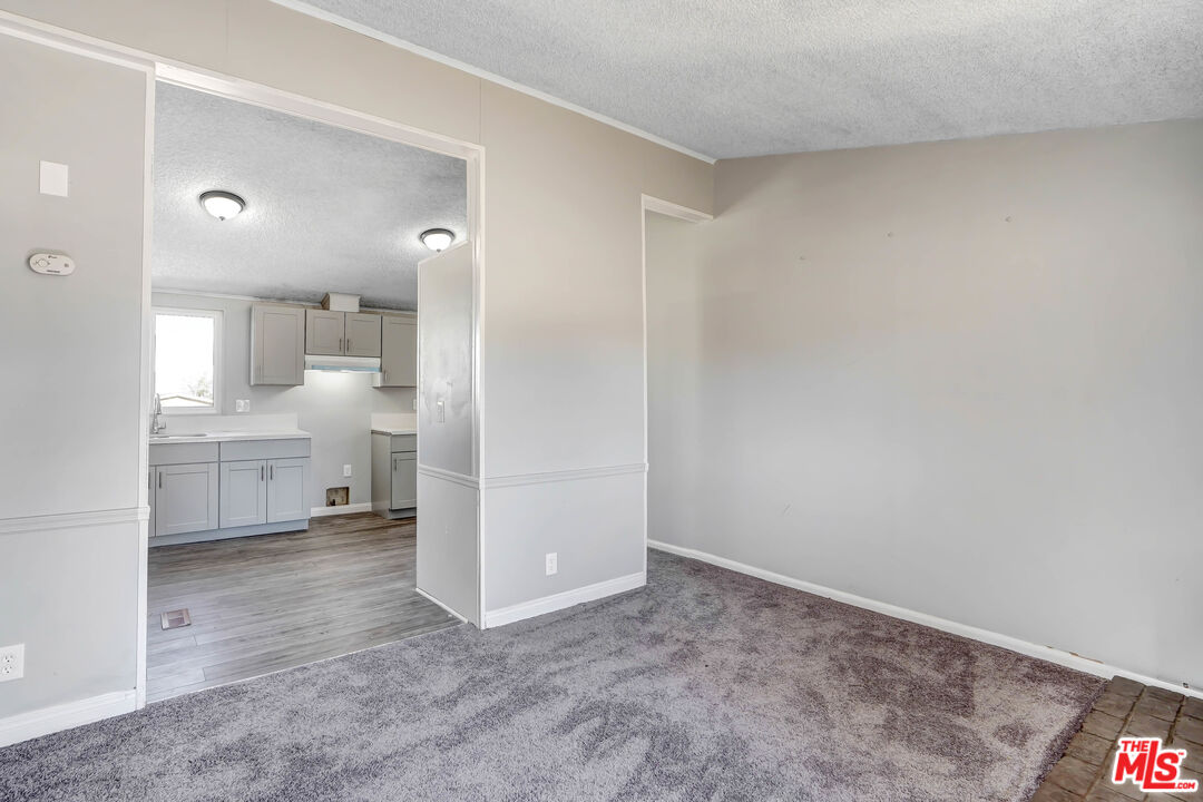 11351 Eaby Road Phelan, CA 92371 - Photo 8 of 23 a view of a kitchen cabinets and a refrigerator