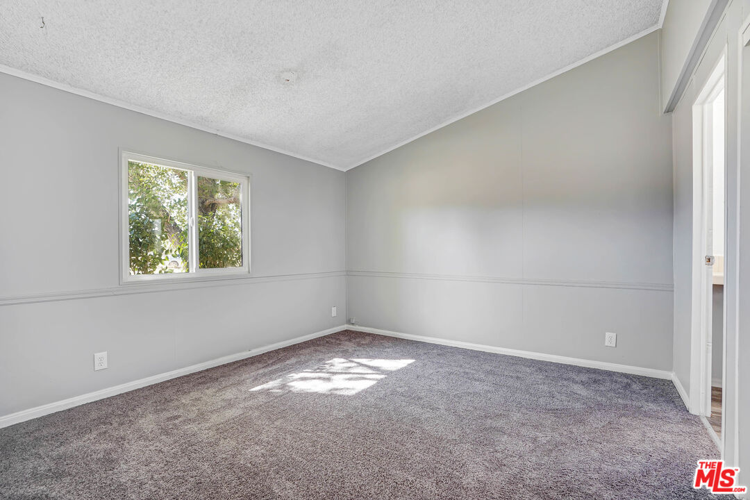 11351 Eaby Road Phelan, CA 92371 - Photo 9 of 23 an empty room with a window