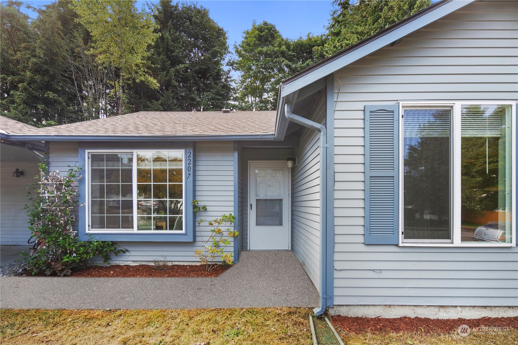 2207 Northeast 23rd Street Renton, WA 98056 - Photo 3 of 34 a front view of a house with a yard and potted plants