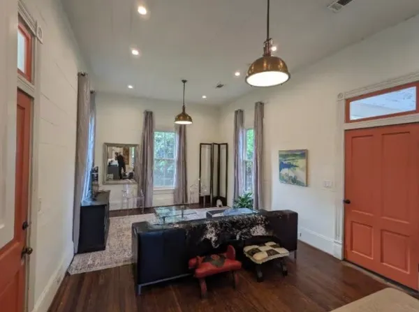 a living room with furniture and a wooden floor