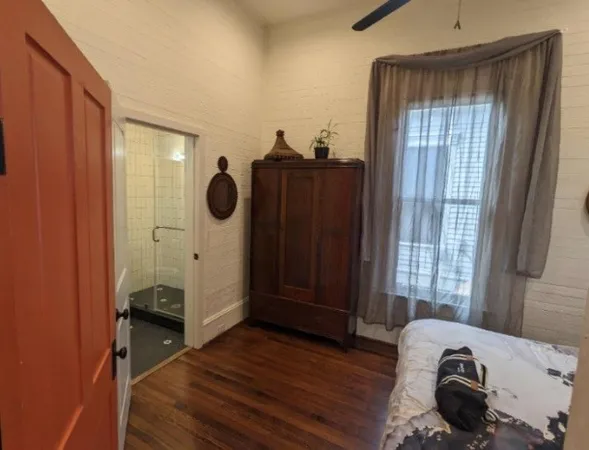a view of bedroom with a bed and wooden floor
