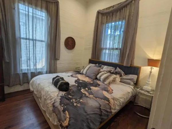 a bedroom with a bed and a window