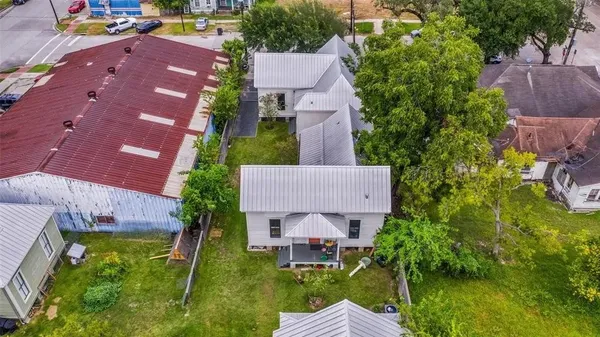 an aerial view of a house with a garden and lake view