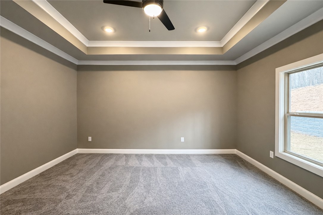 111 Birch Court Westminster, SC 29693 - Photo 15 of 27 This spacious bedroom features a beautiful tray ceiling and plush carpeting, perfect for creating a relaxing atmosphere.
