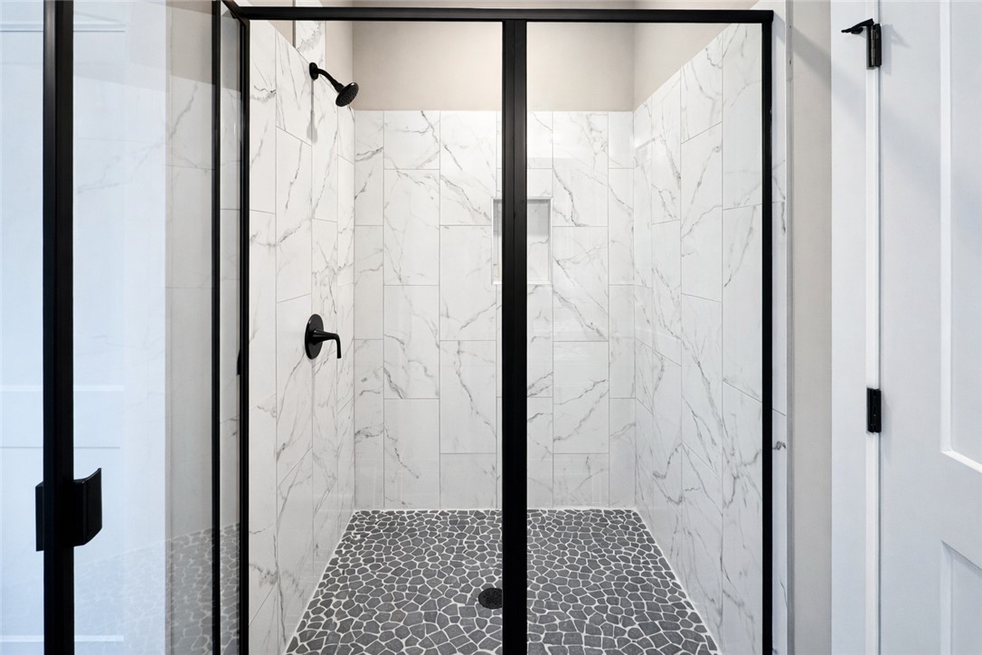 111 Birch Court Westminster, SC 29693 - Photo 17 of 27 This sleek shower showcases contemporary design with contrasting tilework and modern fixtures.