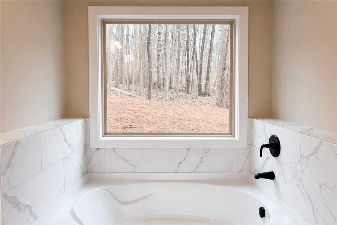 111 Birch Court Westminster, SC 29693 - Photo 18 of 27 This tranquil bathroom offers a serene escape with views of nature.