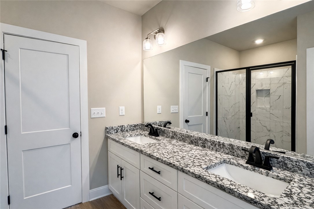 111 Birch Court Westminster, SC 29693 - Photo 19 of 27 This modern bathroom features a dual vanity, sleek fixtures, and a spacious shower.