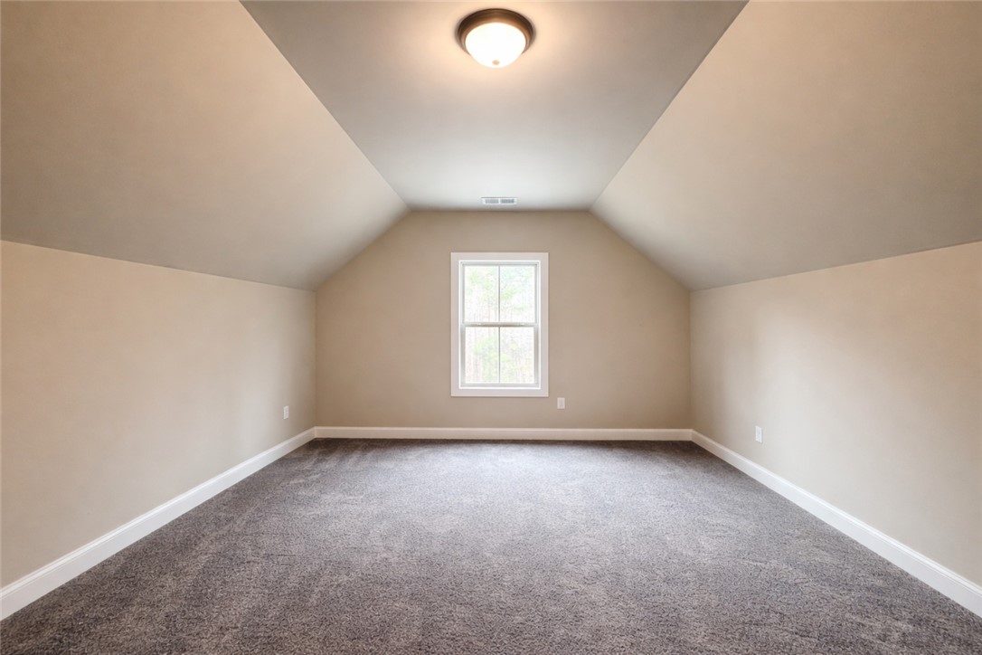 111 Birch Court Westminster, SC 29693 - Photo 24 of 27 This spacious bonus room features a pitched ceiling and ample natural light, offering versatile living.