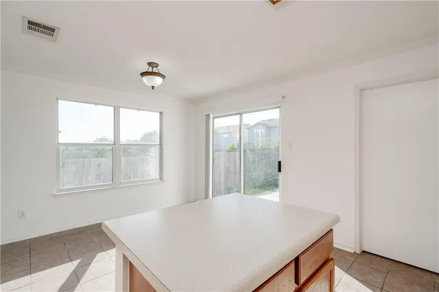 a view of a room that has a table and chairs in it