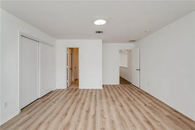 a view of a room with wooden floor and bathroom