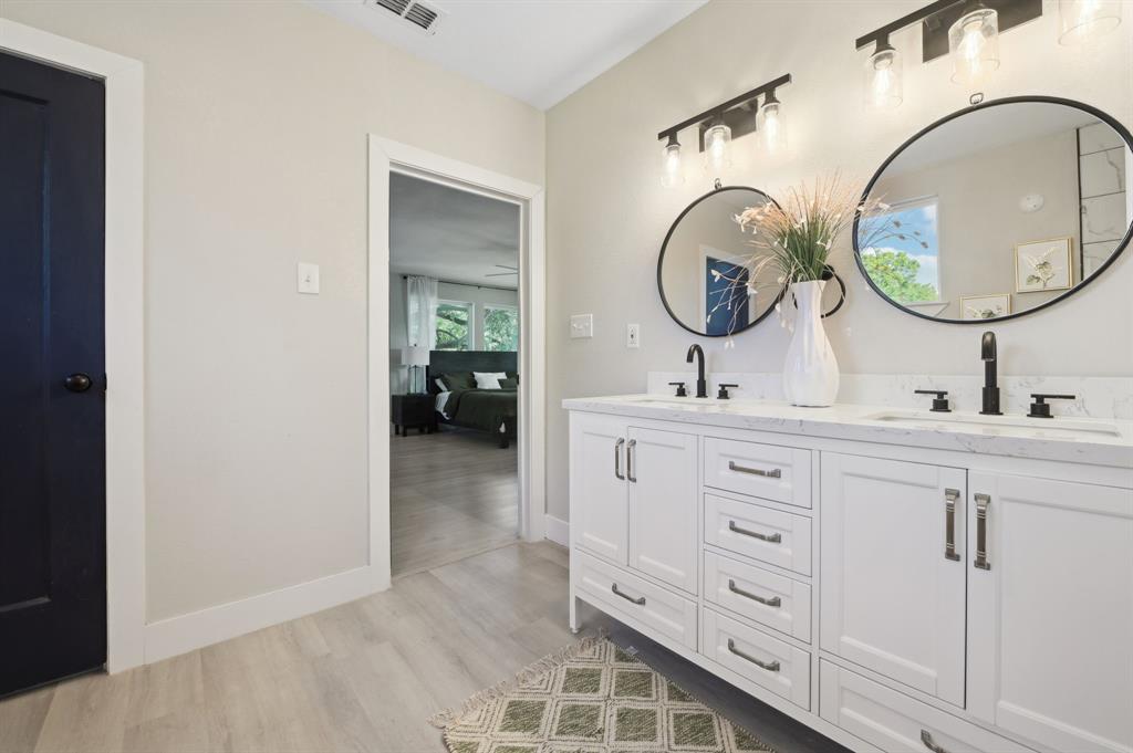 702 Griffith Avenue Terrell, TX 75160 - Photo 27 of 40 a bathroom with a double vanity sink and a mirror