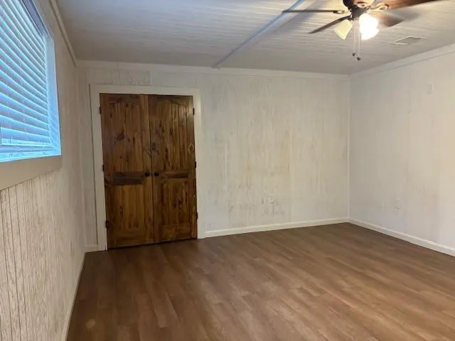 wooden floor in an empty room with a window