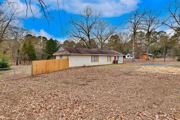 a front view of house with trees