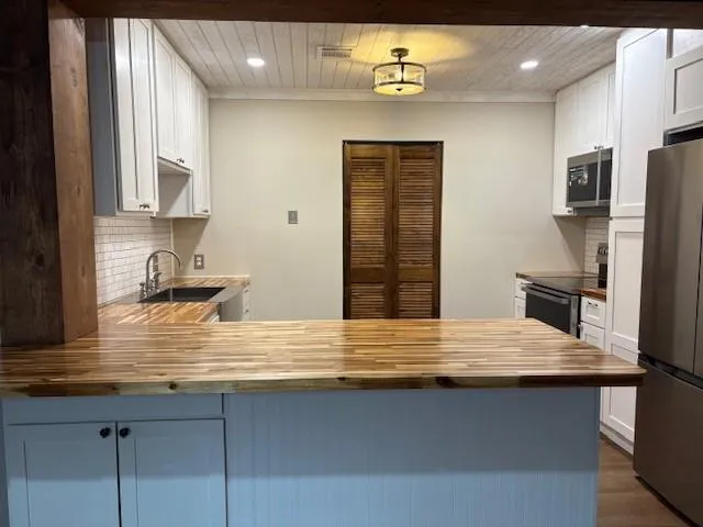 a view of kitchen with stainless steel appliances granite countertop a sink counter space and cabinets