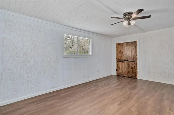a view of an empty room with wooden floor