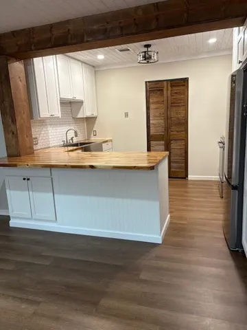a view of kitchen with stainless steel appliances granite countertop a sink and a stove
