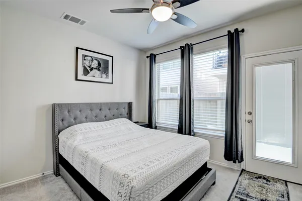 a bedroom with a large bed and a chandelier