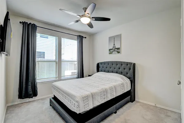 a large bed sitting in a bedroom next to a window