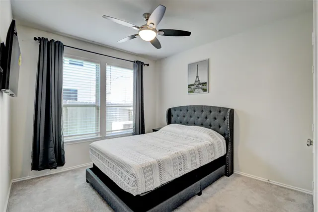 a large bed sitting in a bedroom next to a window