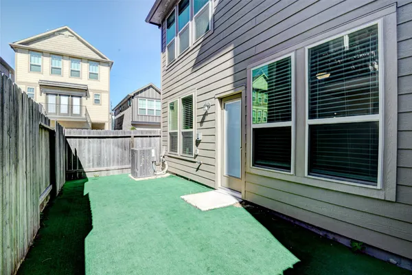 a view of a house with backyard and wooden fence