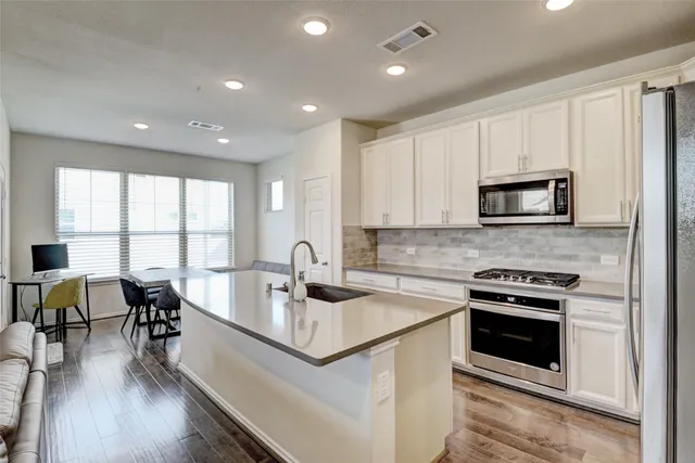 a kitchen with a stove a sink and a microwave