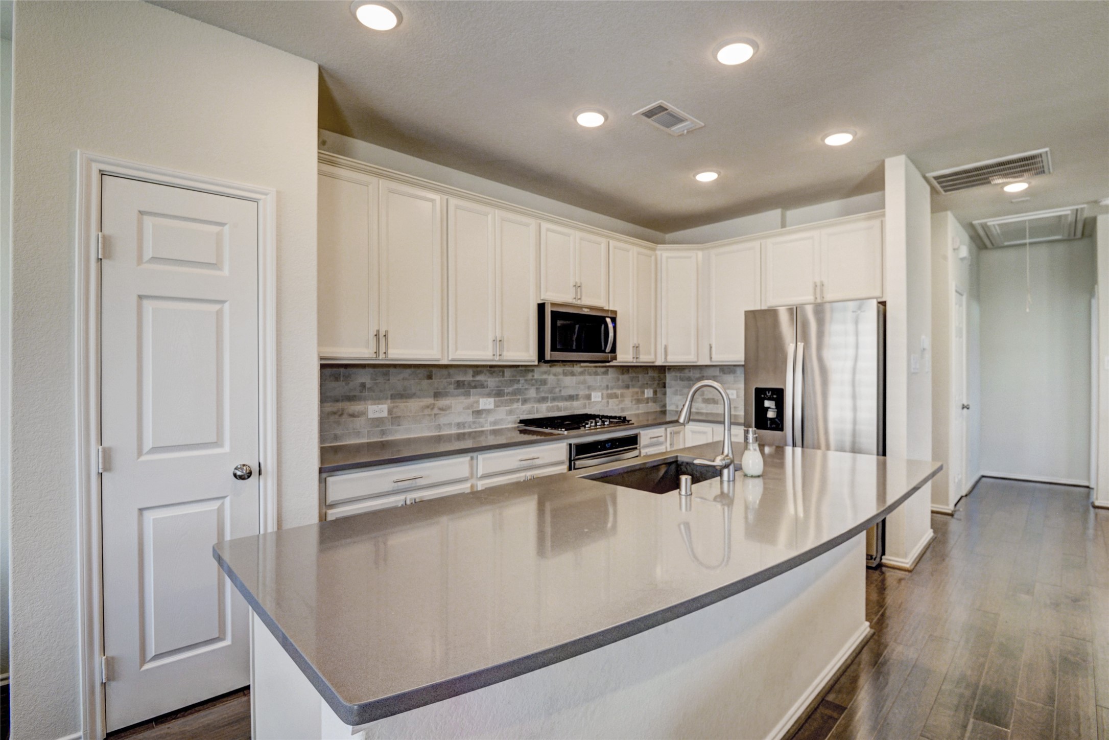 3104 Roseland Terrace Lane Houston, TX 77063 - Photo 6 of 14 a kitchen with stainless steel appliances granite countertop a refrigerator a stove and a sink with wooden floor