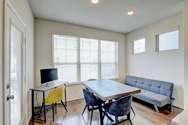 a view of a dining room with furniture and wooden floor