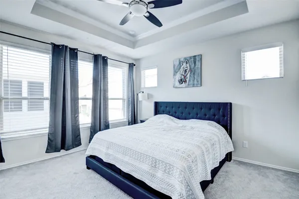 a bedroom with a large bed and a window