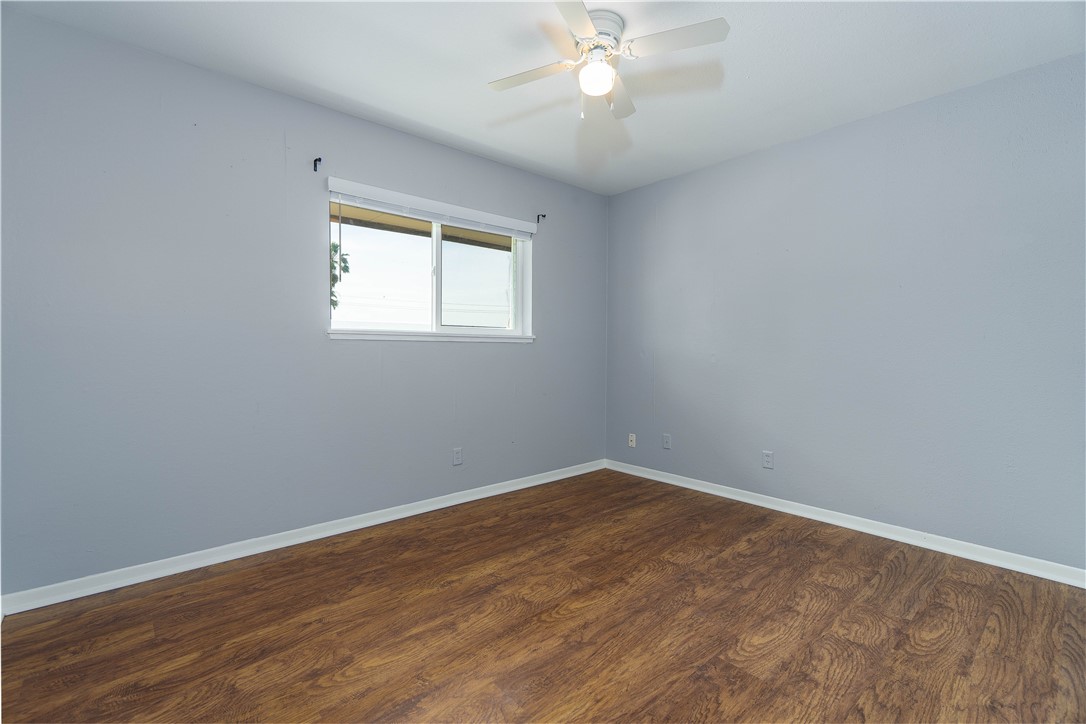 6232 Weber Road Corpus Christi, TX 78413 - Photo 21 of 23 wooden floor in an empty room with a window