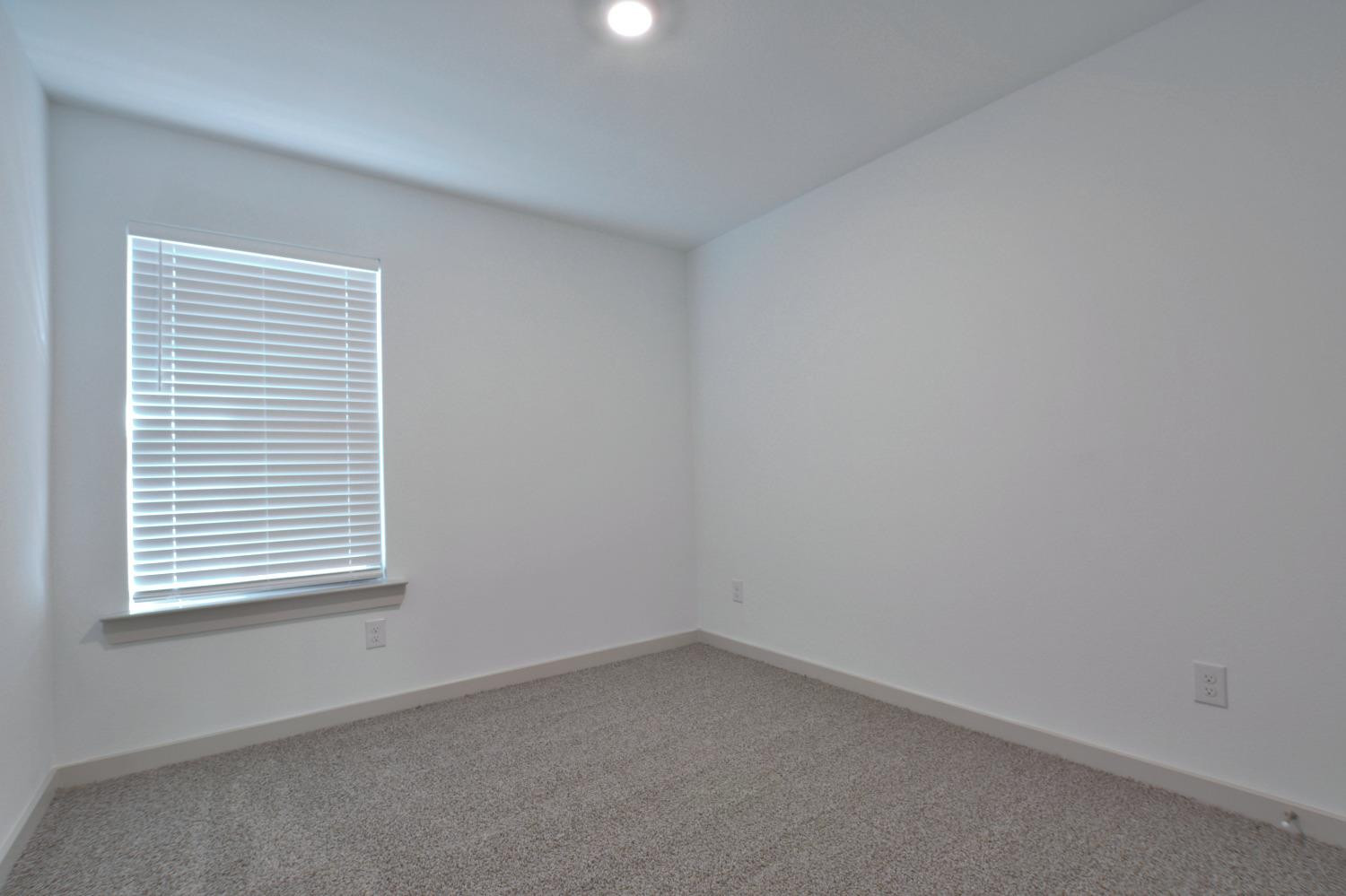 7438 8th Street Lubbock, TX 79416 - Photo 15 of 18 an empty room with a window