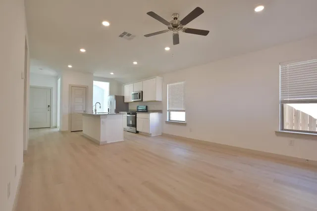 a view of a kitchen with a sink and a window