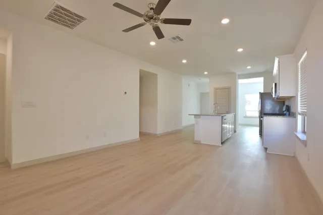 a view of a kitchen with a sink and a refrigerator