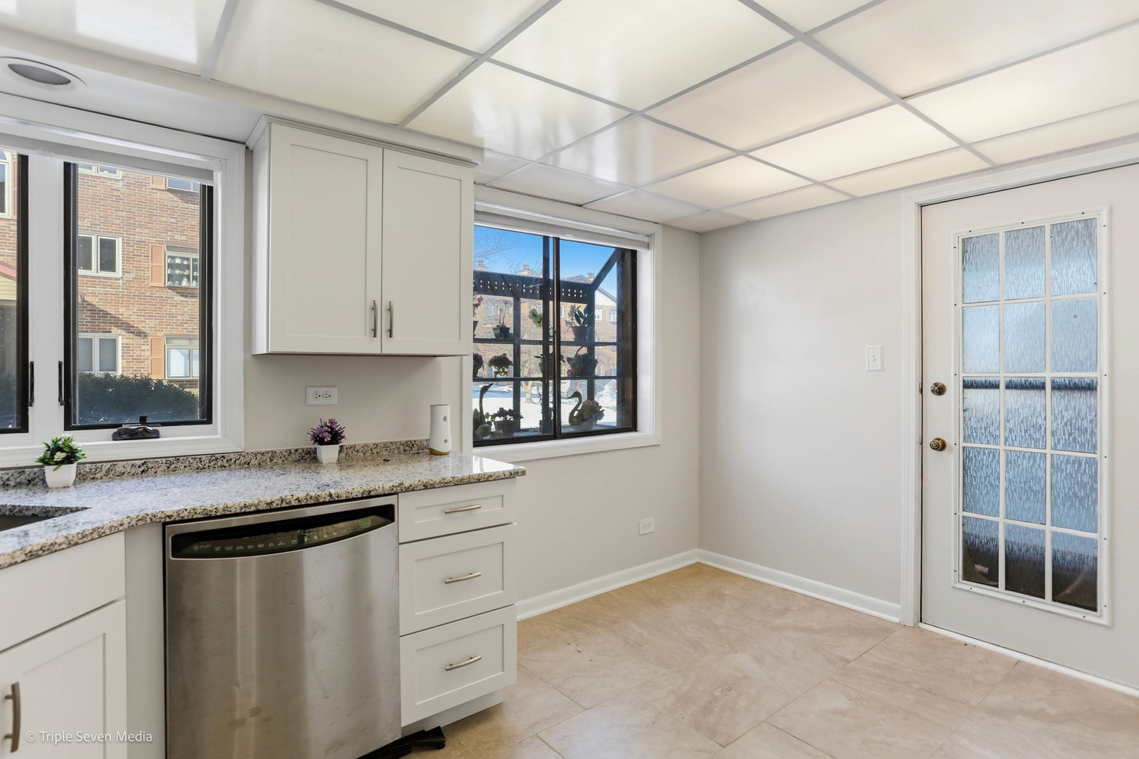 17236 Ridgeland Avenue, Unit 412 Tinley Park, IL 60477 - Photo 11 of 23 a kitchen with granite countertop a sink window and cabinets