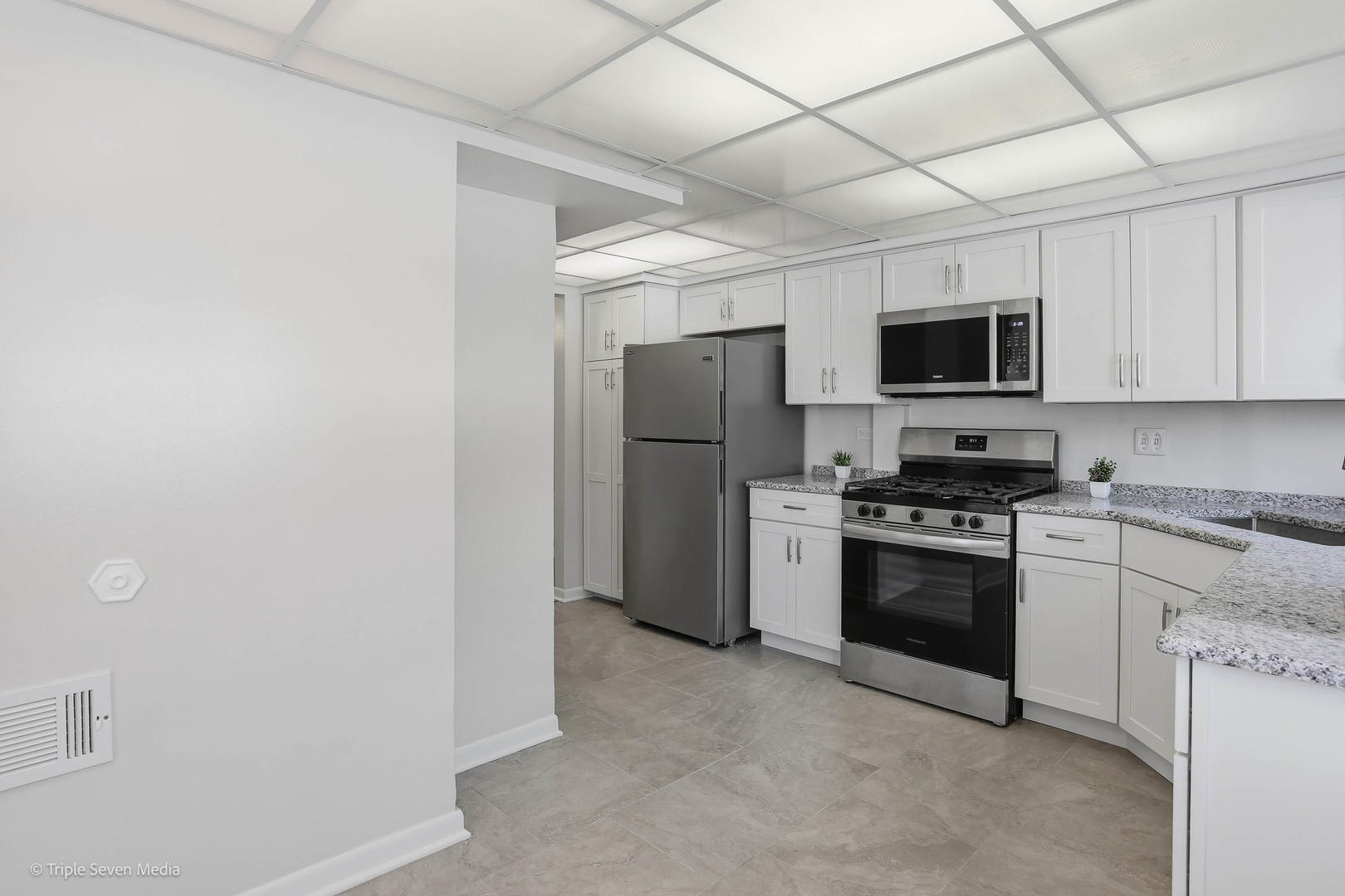 17236 Ridgeland Avenue, Unit 412 Tinley Park, IL 60477 - Photo 12 of 23 a kitchen with stainless steel appliances a refrigerator stove and microwave